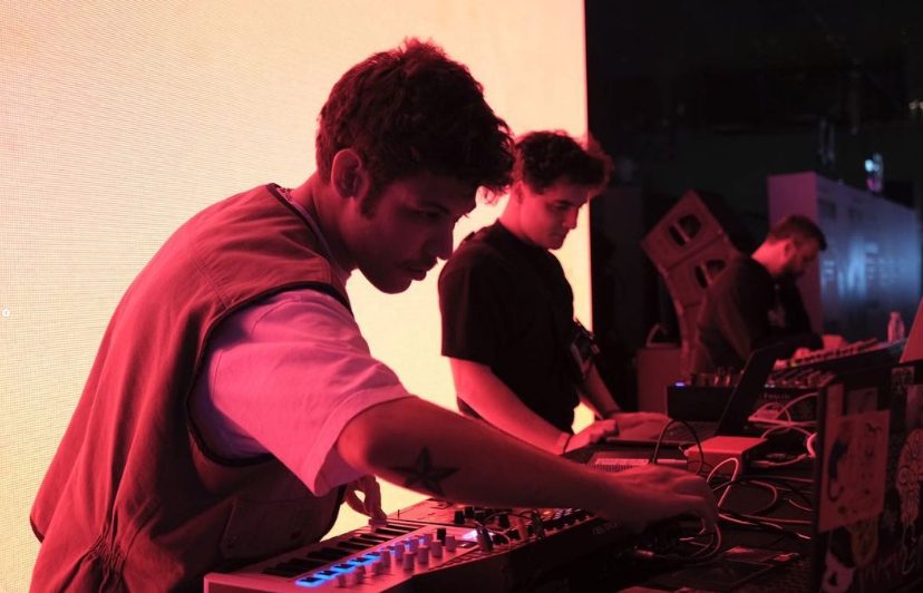 Fosil performing live electronics under red stage light at SónarScreen